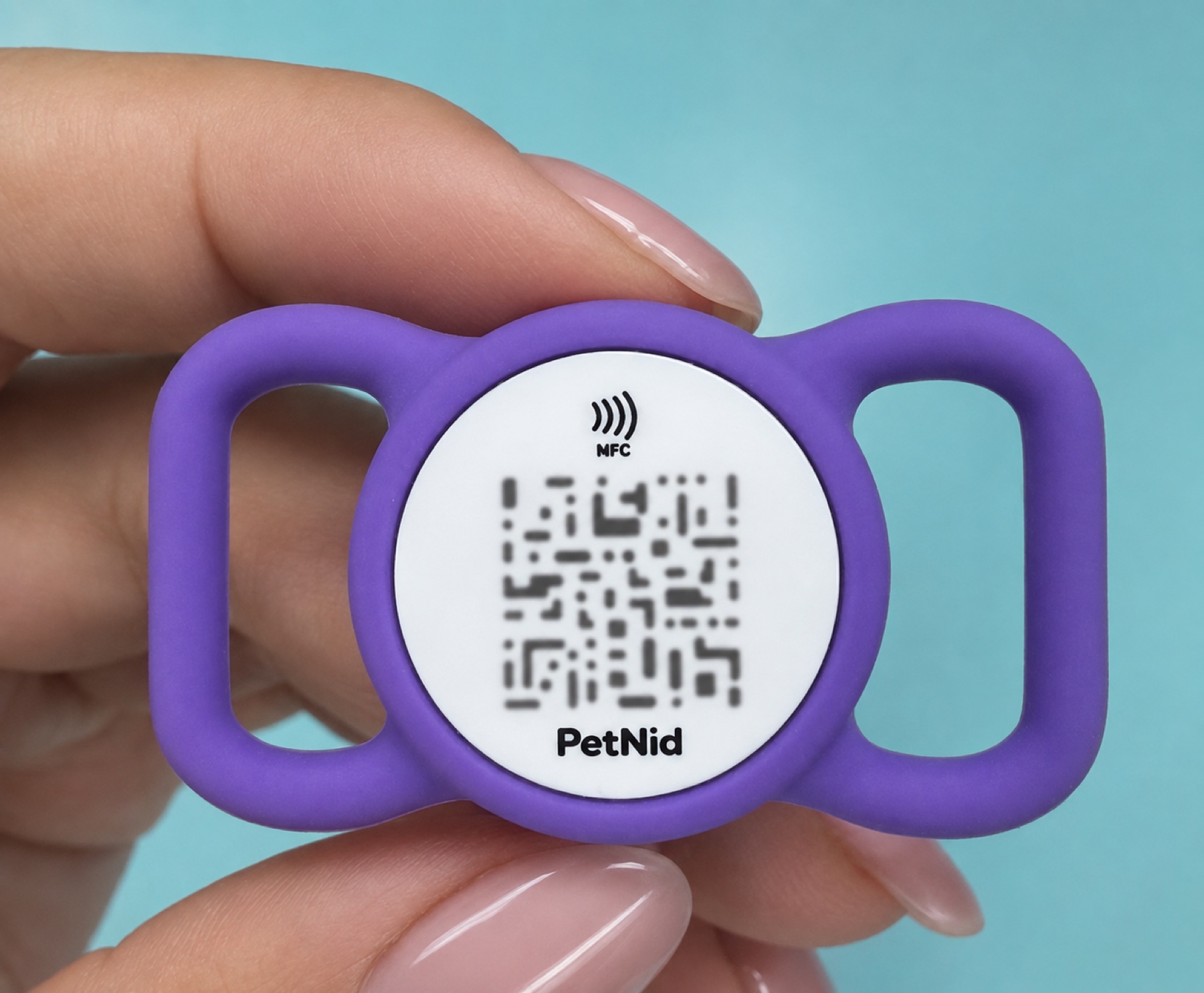 Purple PetNid ID tag with NFC and QR code held in a hand
